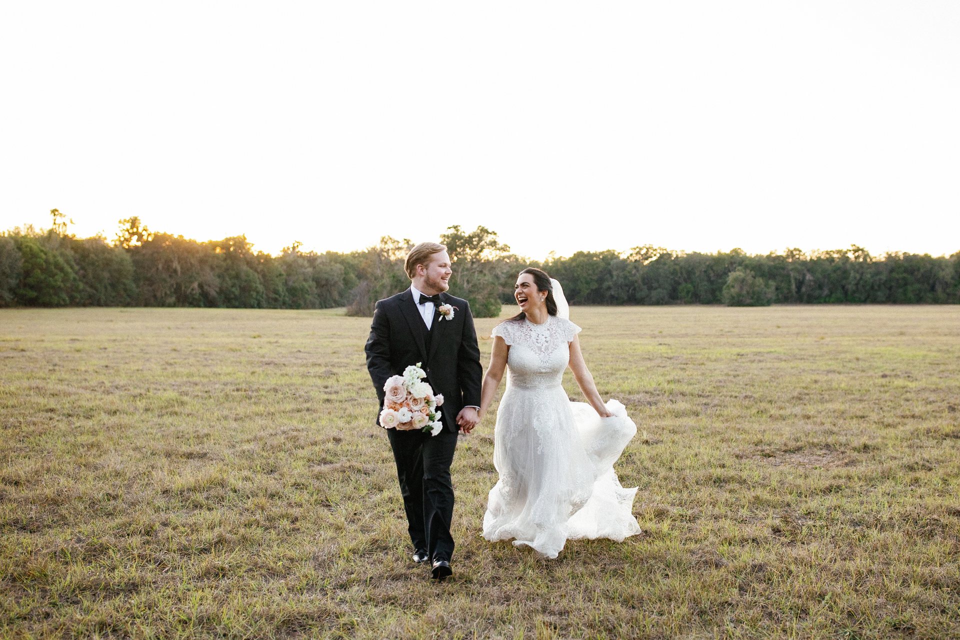 Sunlit fine-art wedding couple portrait in grassy meadow, graded by InPix.Me